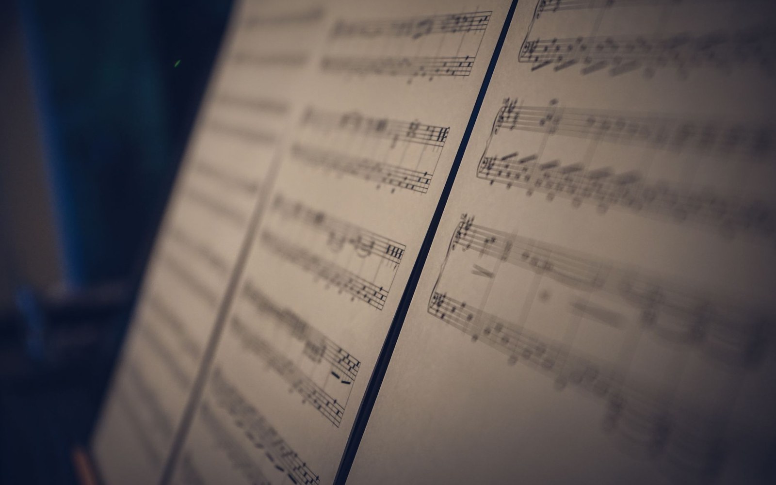 Sheet music with piano staves and notes displayed on a stand, shot at an angle